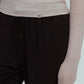 detail shot of a woman wearing light grey  ballet wool shirt shown neiwai active logo and brown pants