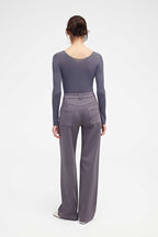 back of woman in purple v neck sweater