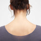 close up of woman in purple v neck sweater from back
