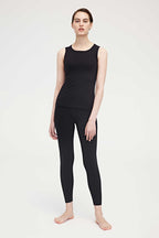 woman wearing a black tank and leggings