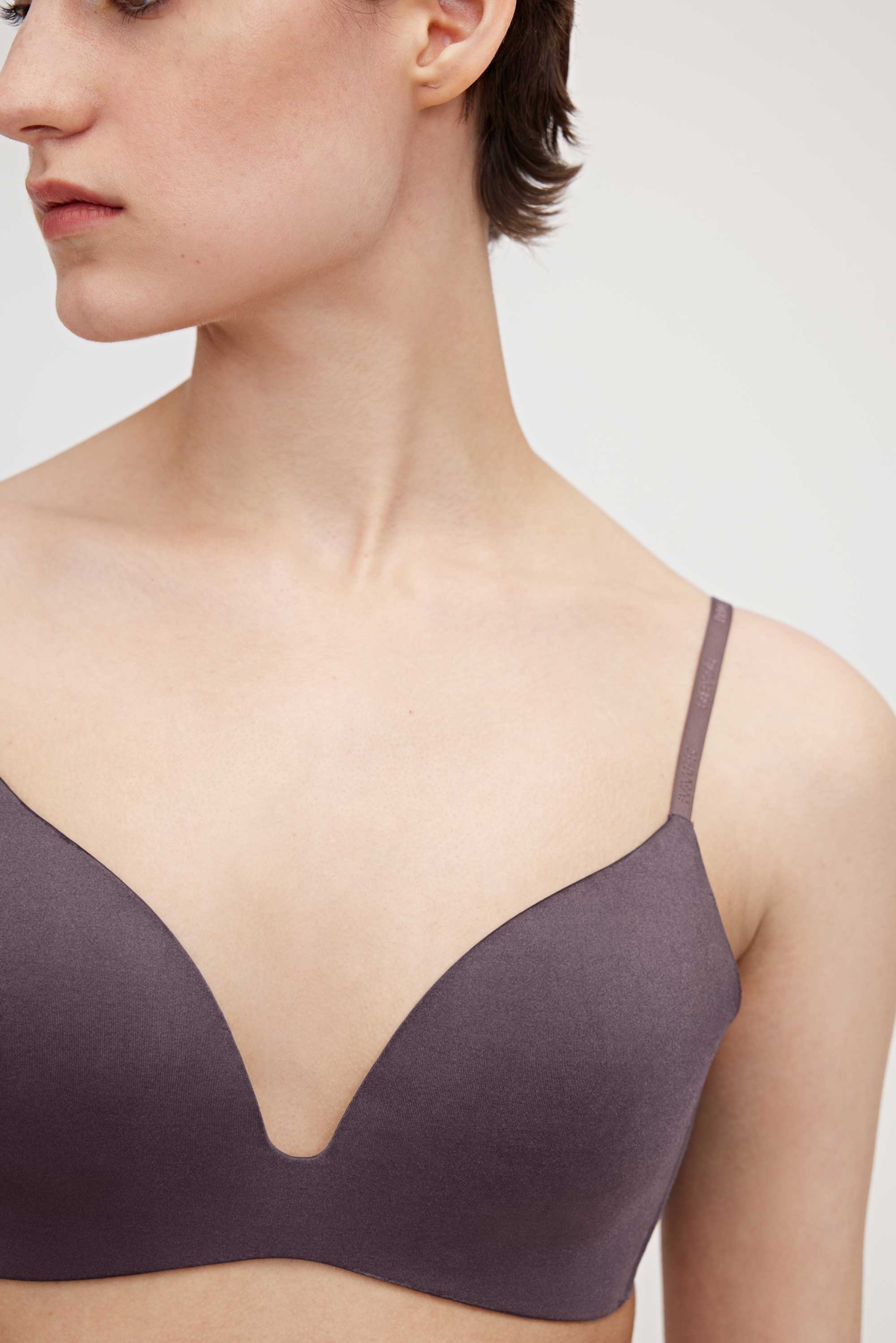 A woman wearing a purple bra