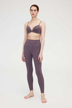 Woman wearing purple bra and leggings