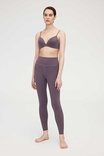 Woman wearing purple bra and leggings