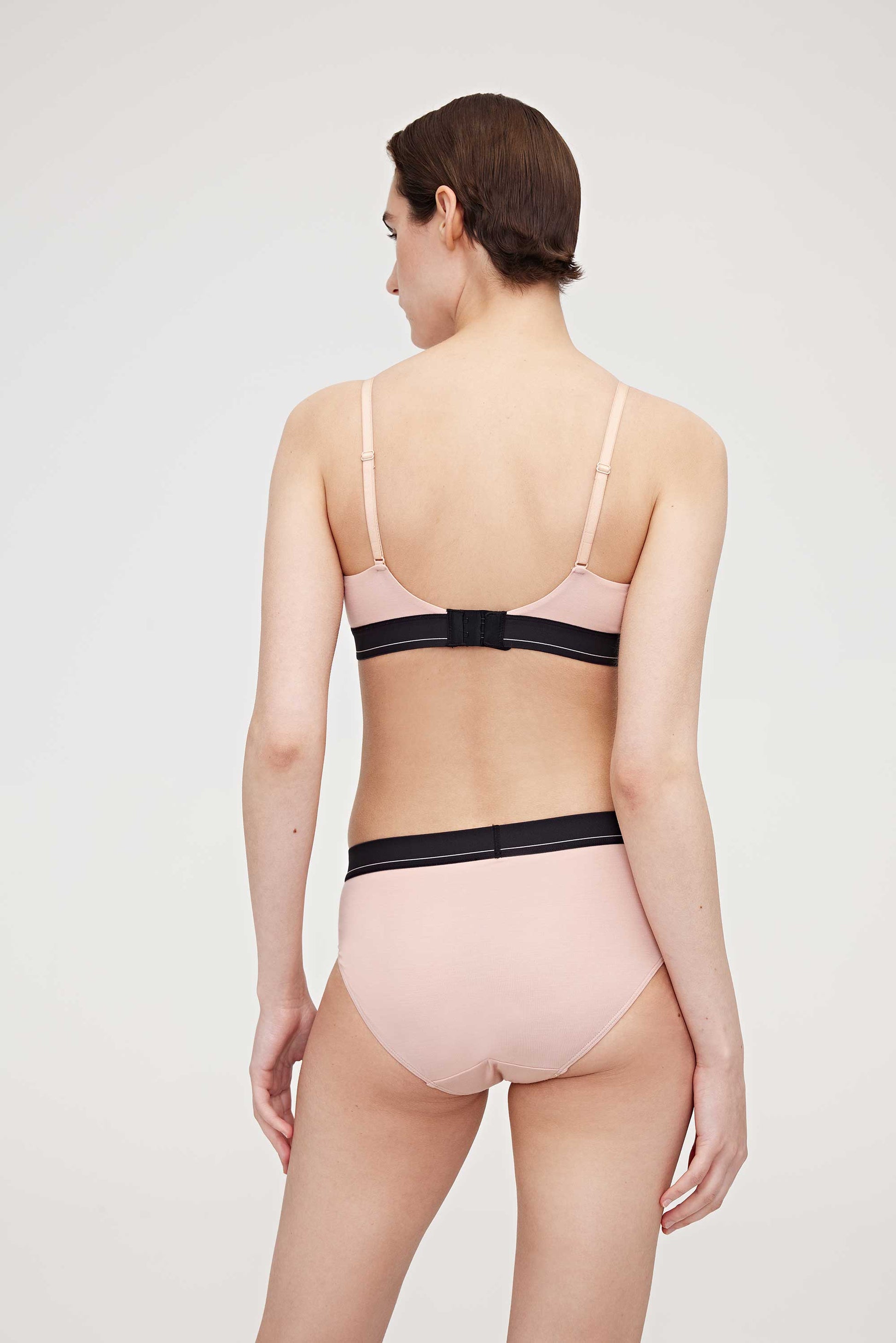 back of woman in pink bra and brief