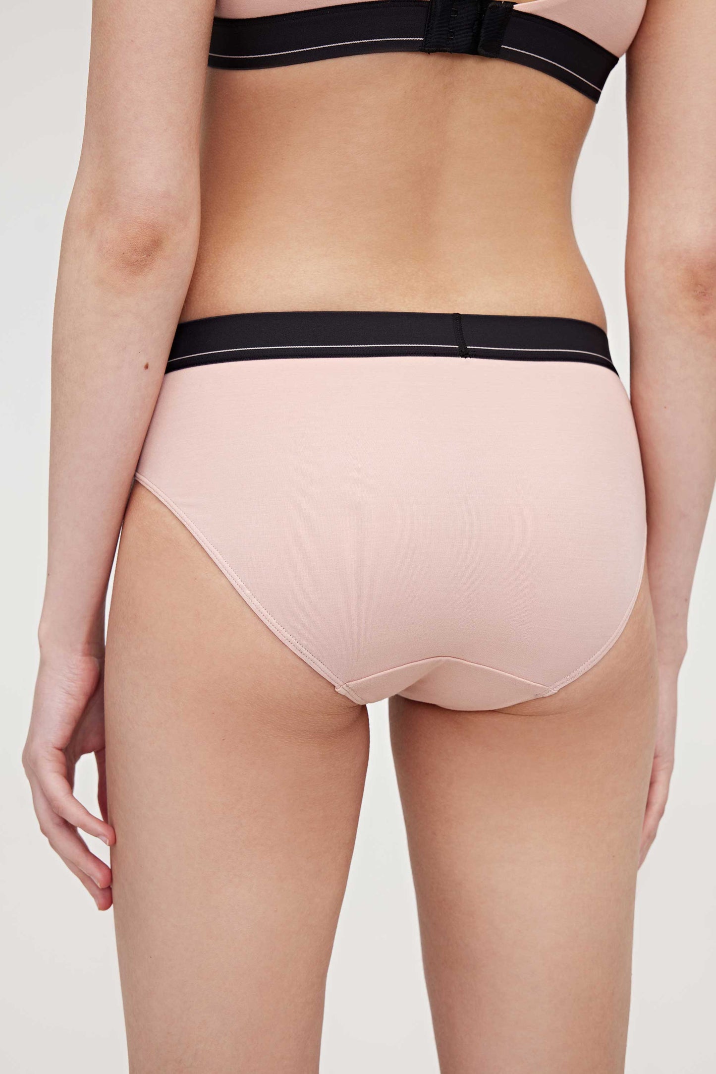 back of woman in pink brief