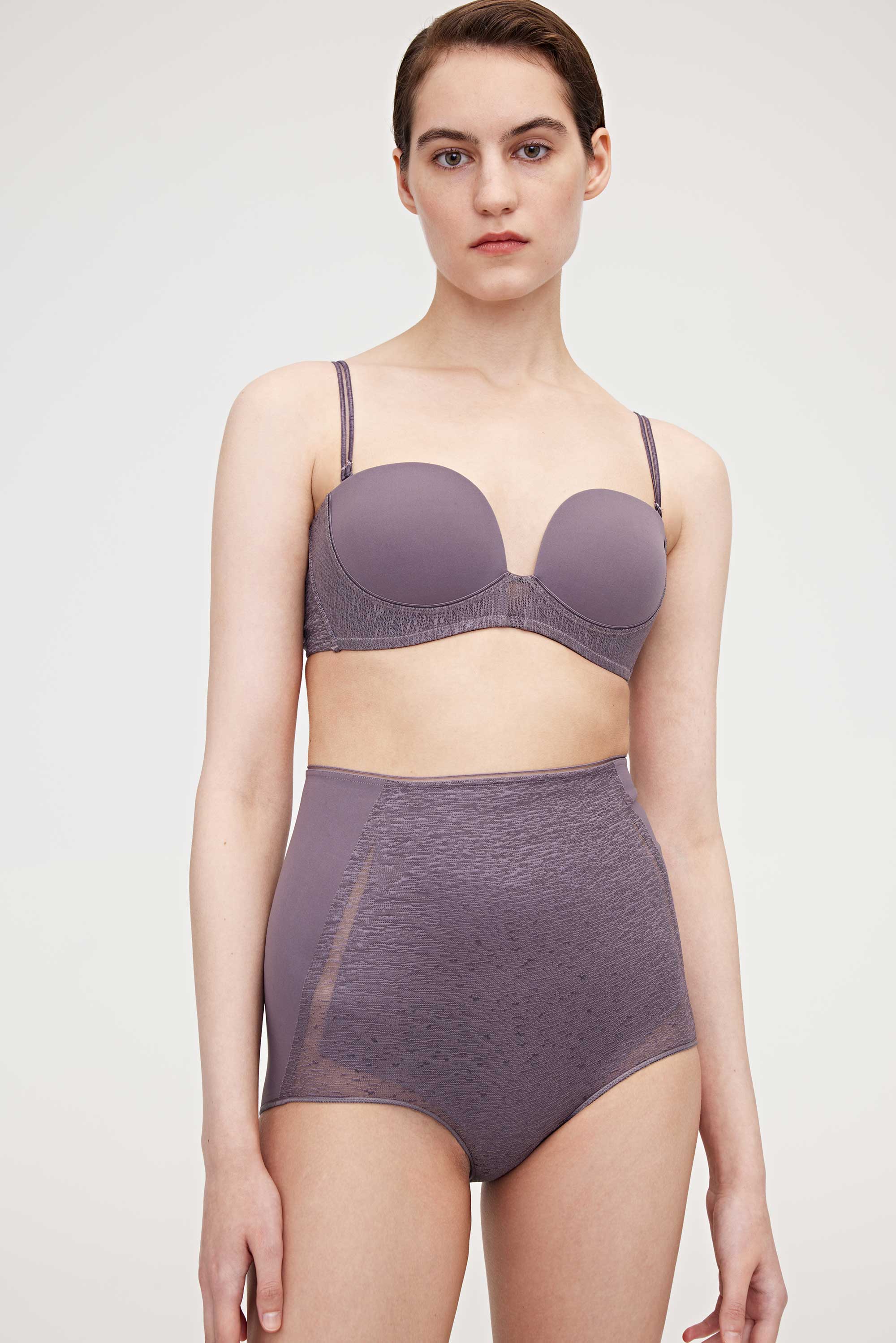 Woman wearing purple bra and high waist brief