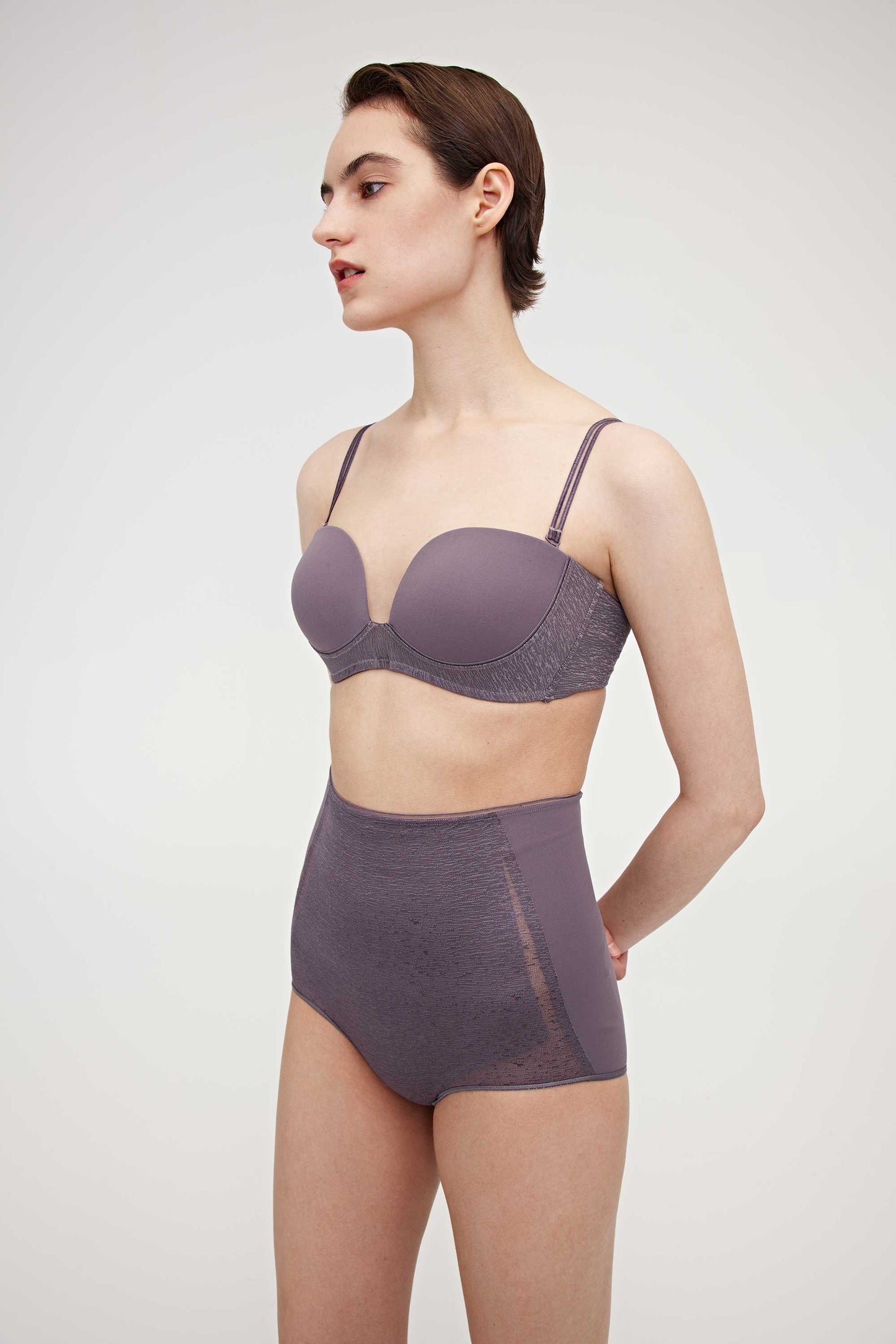 Woman wearing purple bra and high waist brief