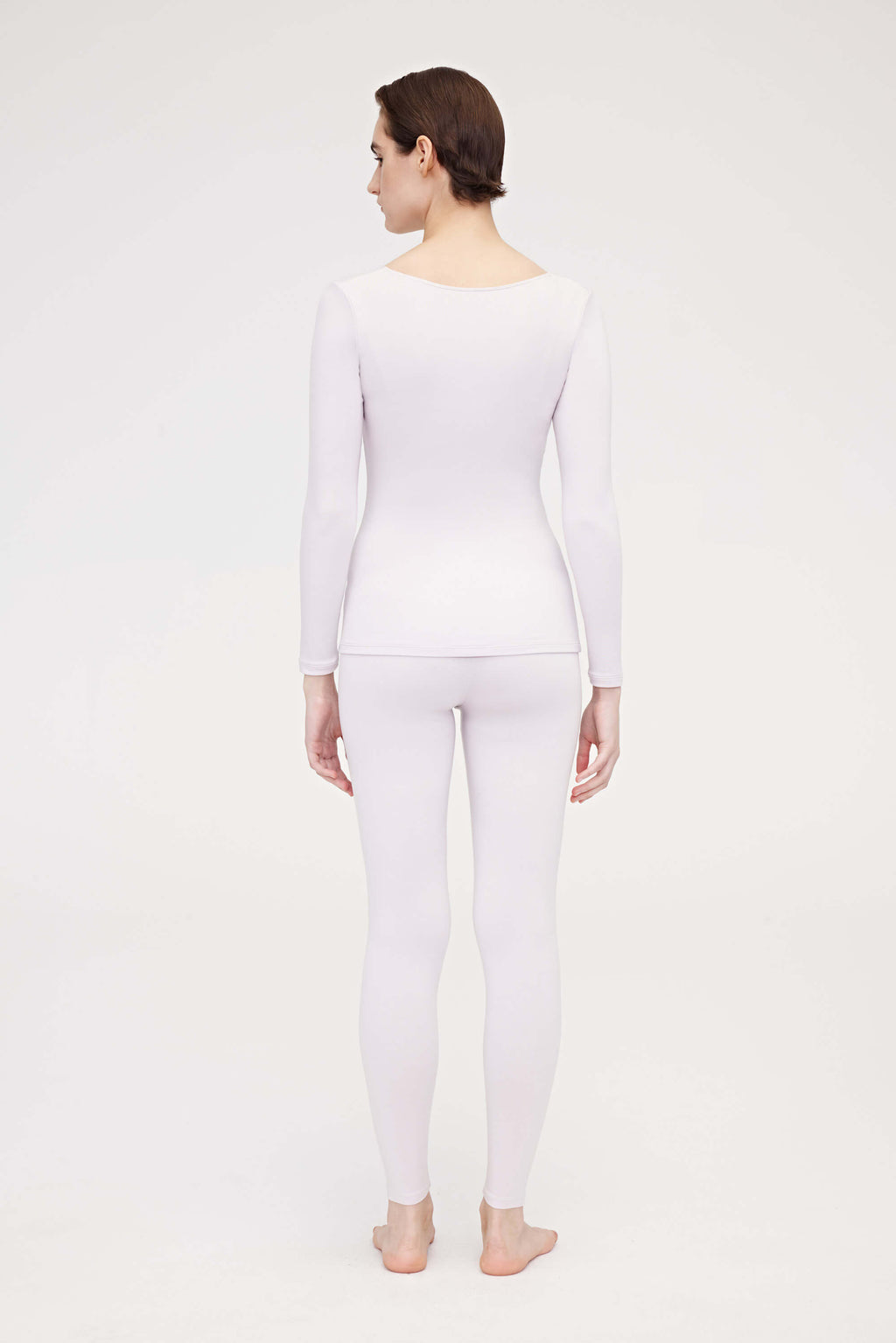 back of woman in light pink thermal set