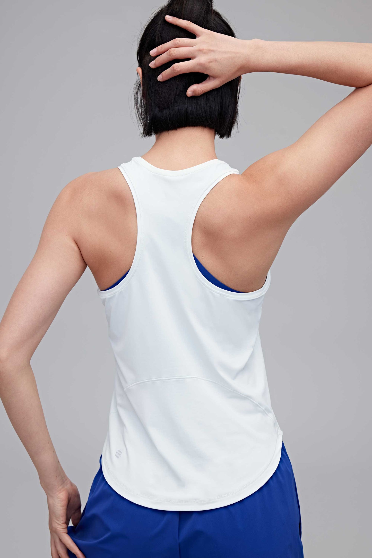 back of woman in white tank