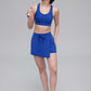 woman in blue sports bra and skorts