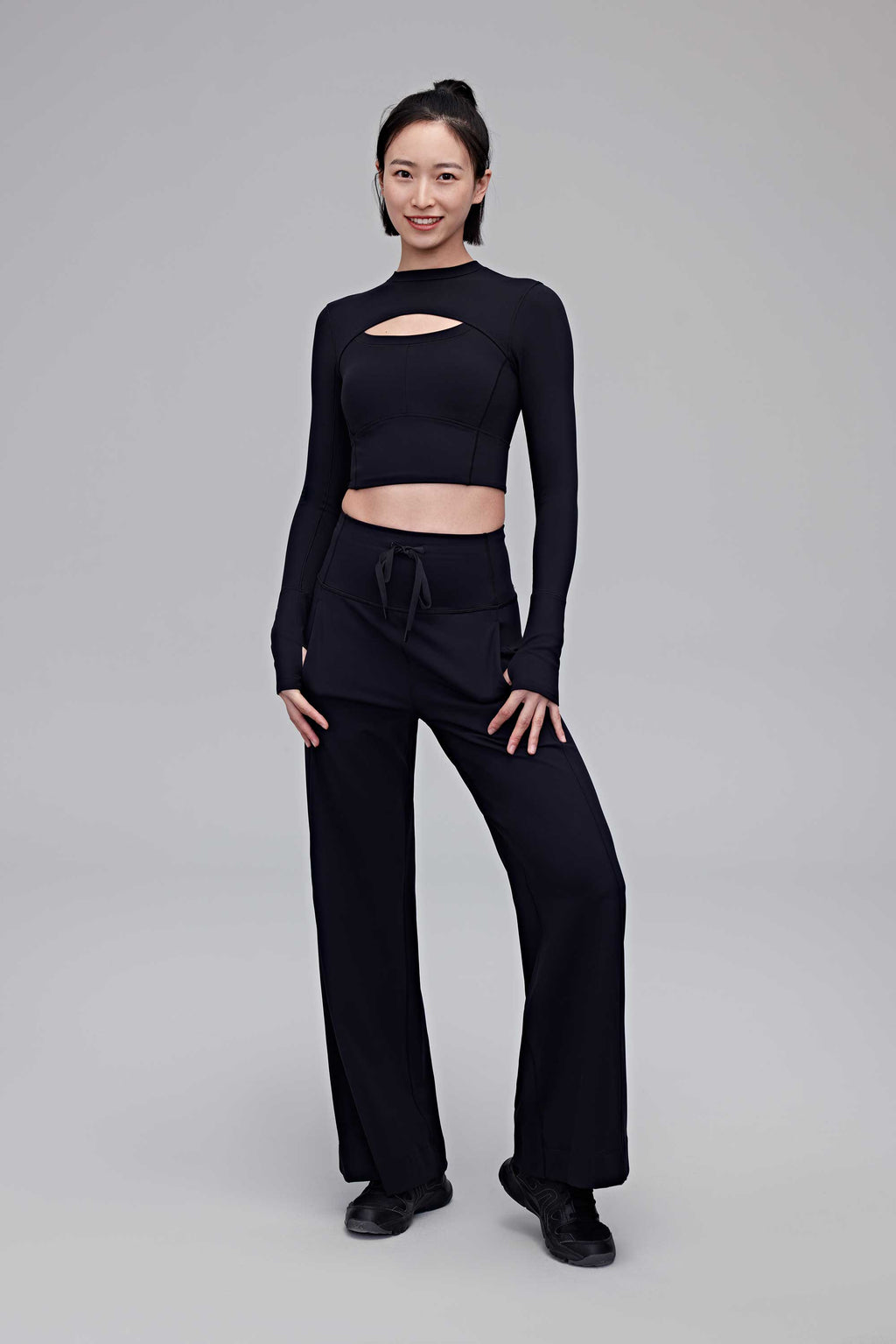 A woman wearing a black top and black pants