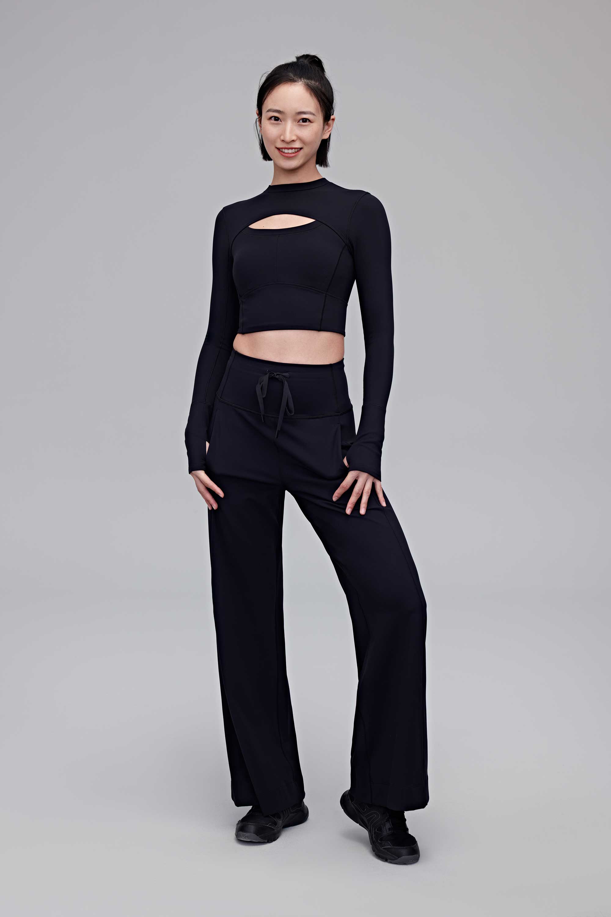 A woman wearing a black top and black pants