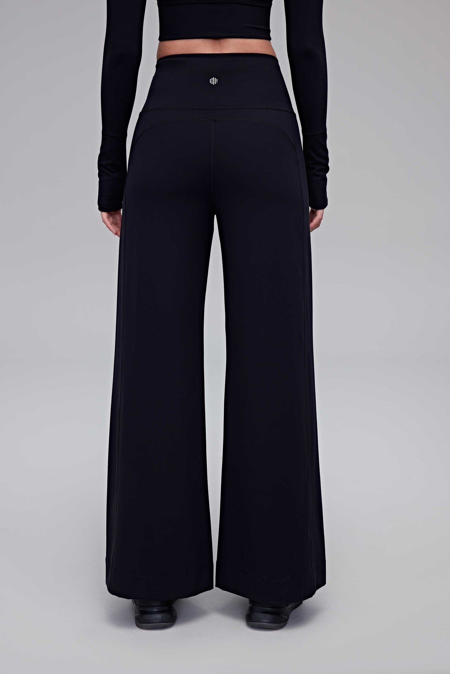 A woman wearing black pants