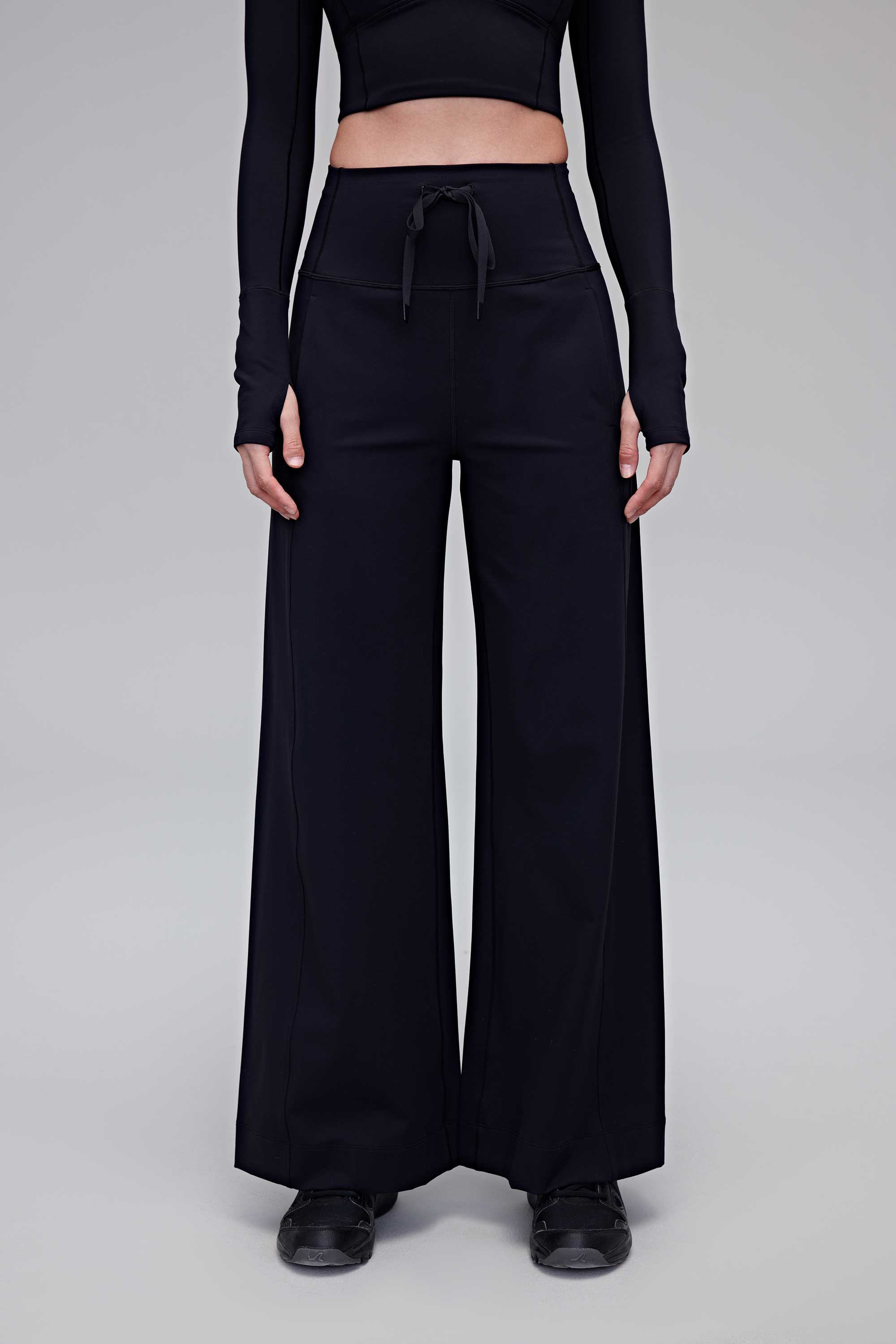 A woman wearing black pants