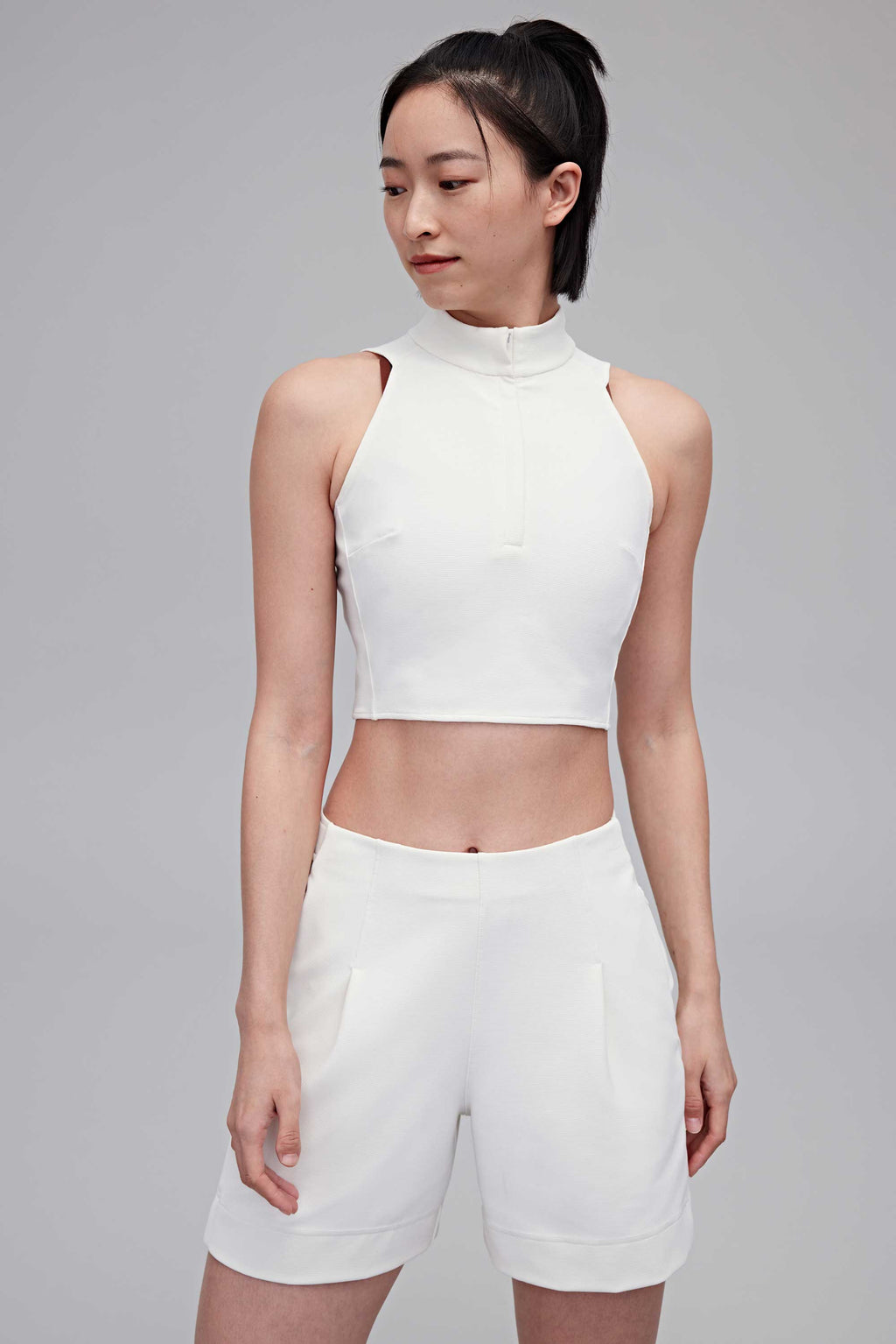 woman in white tank and white shorts