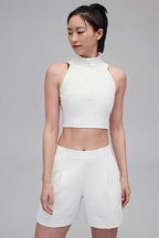 woman in white tank and white shorts