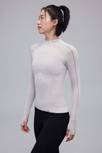 woman in cream mock neck top