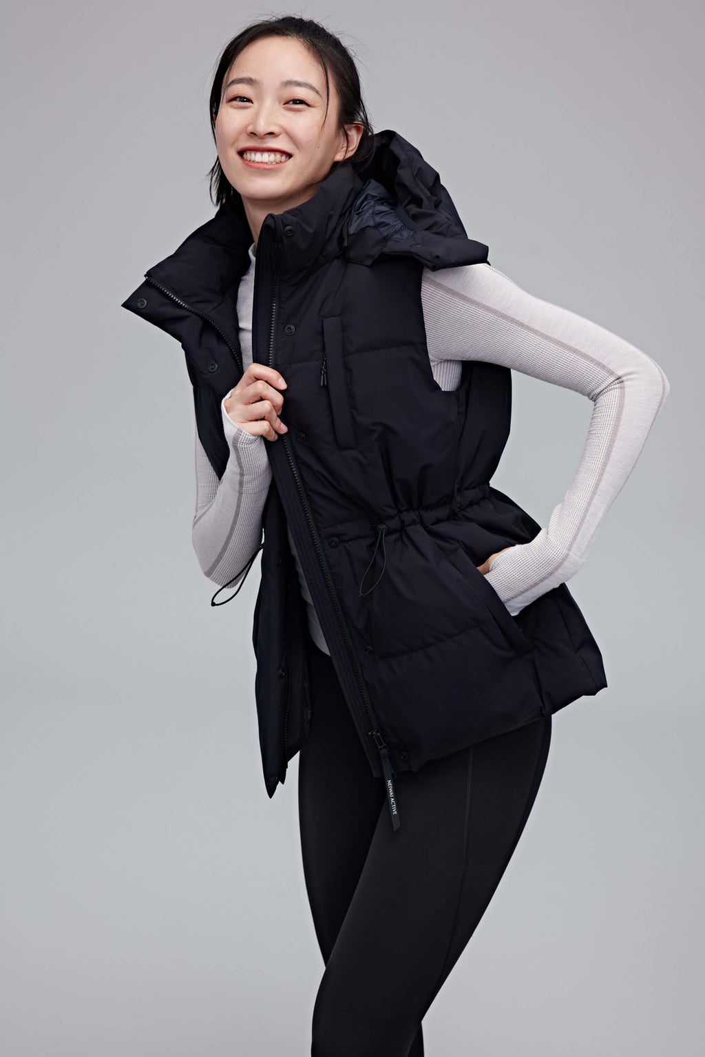 woman in black hooded down vest