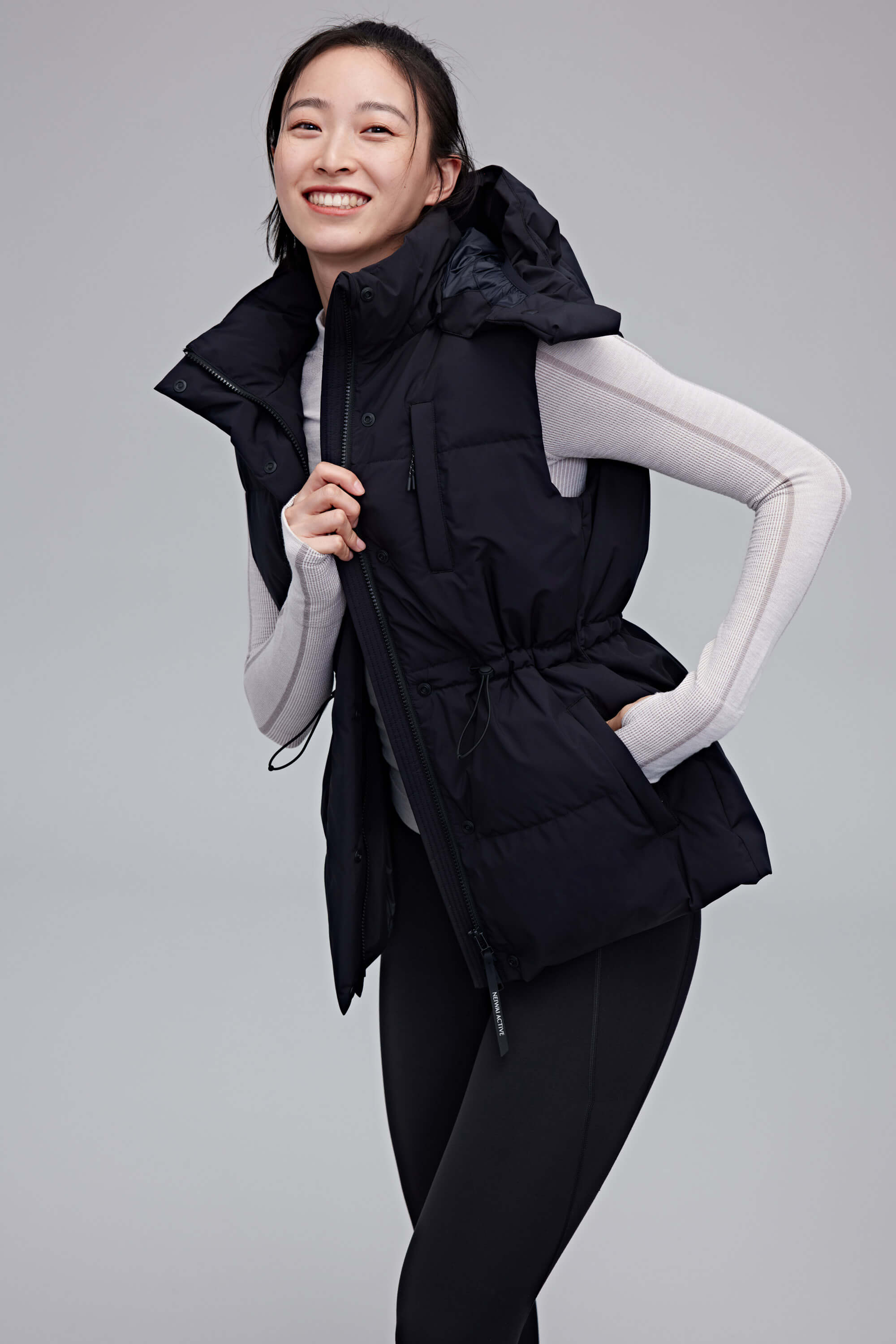 woman in black hooded down vest