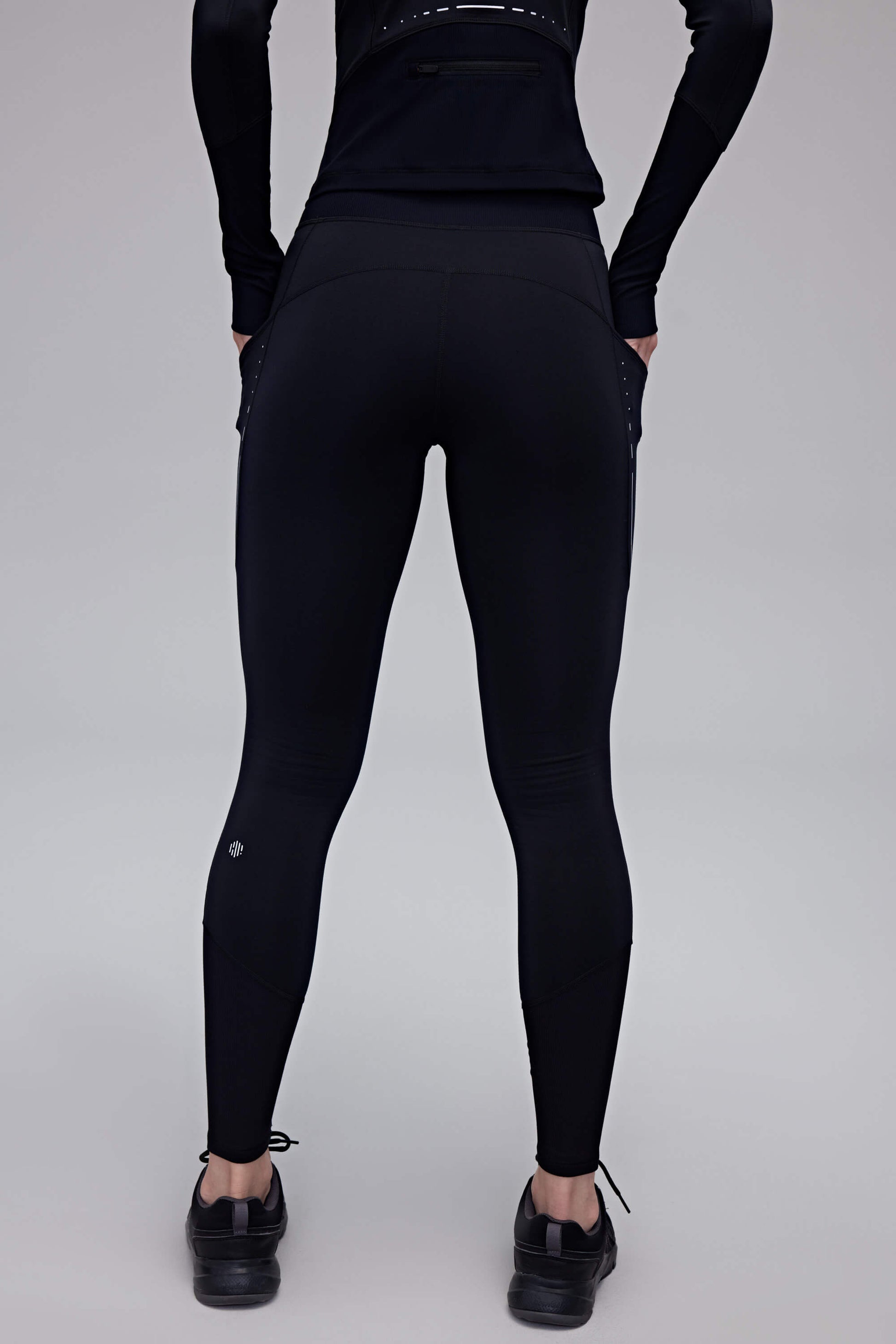 back of woman in black leggings