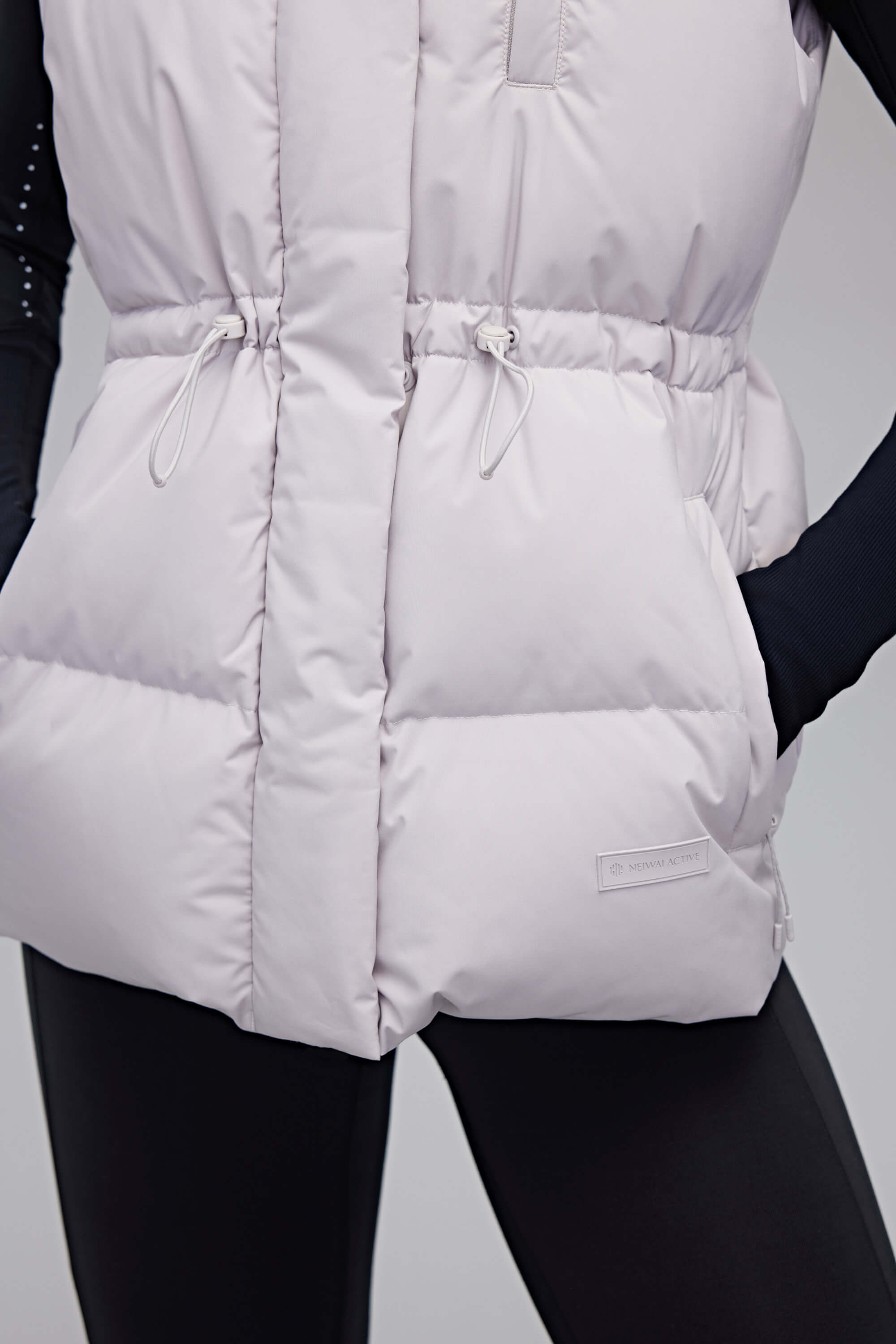 close up of woman in grey down vest