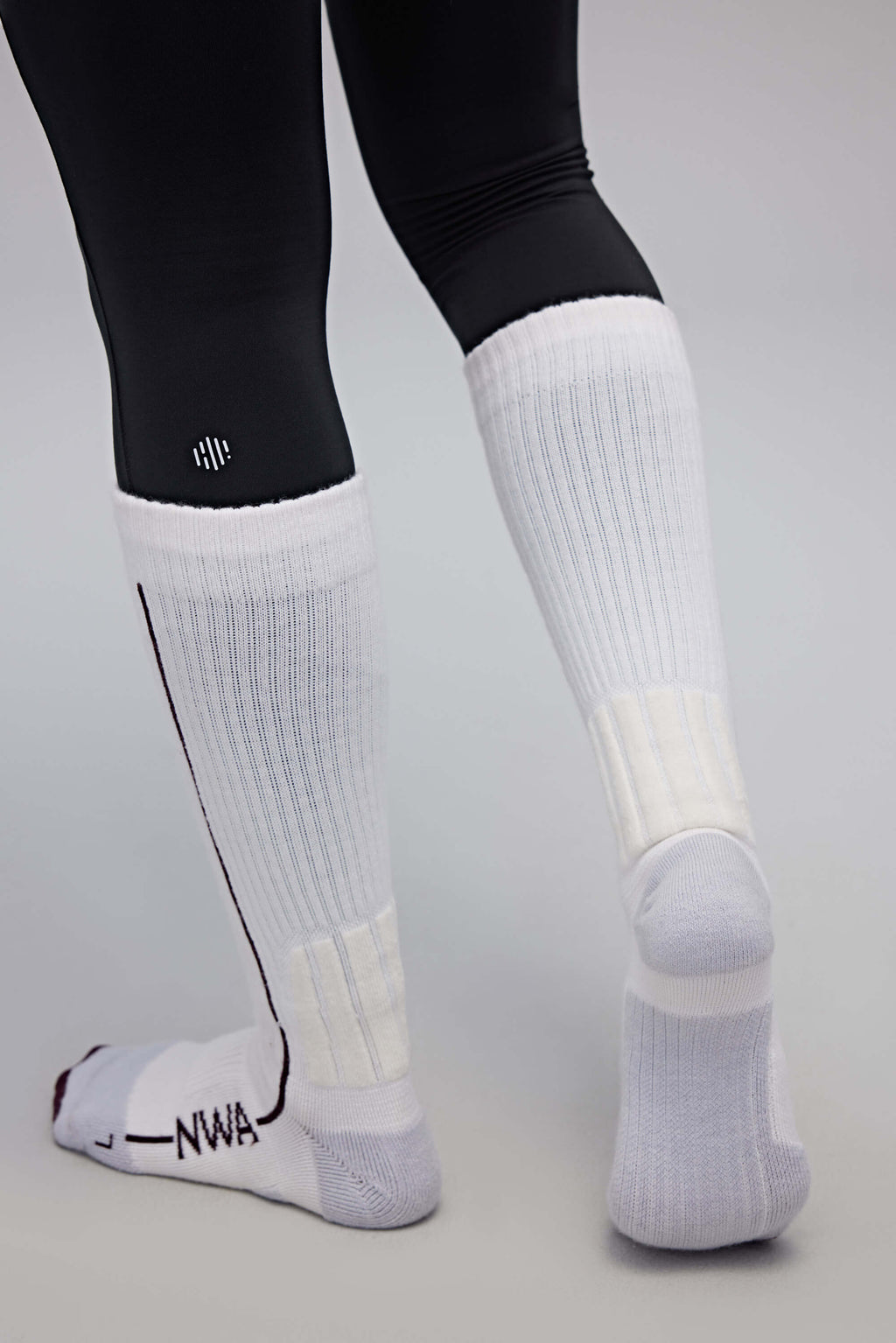 back of a person wearing white wool socks