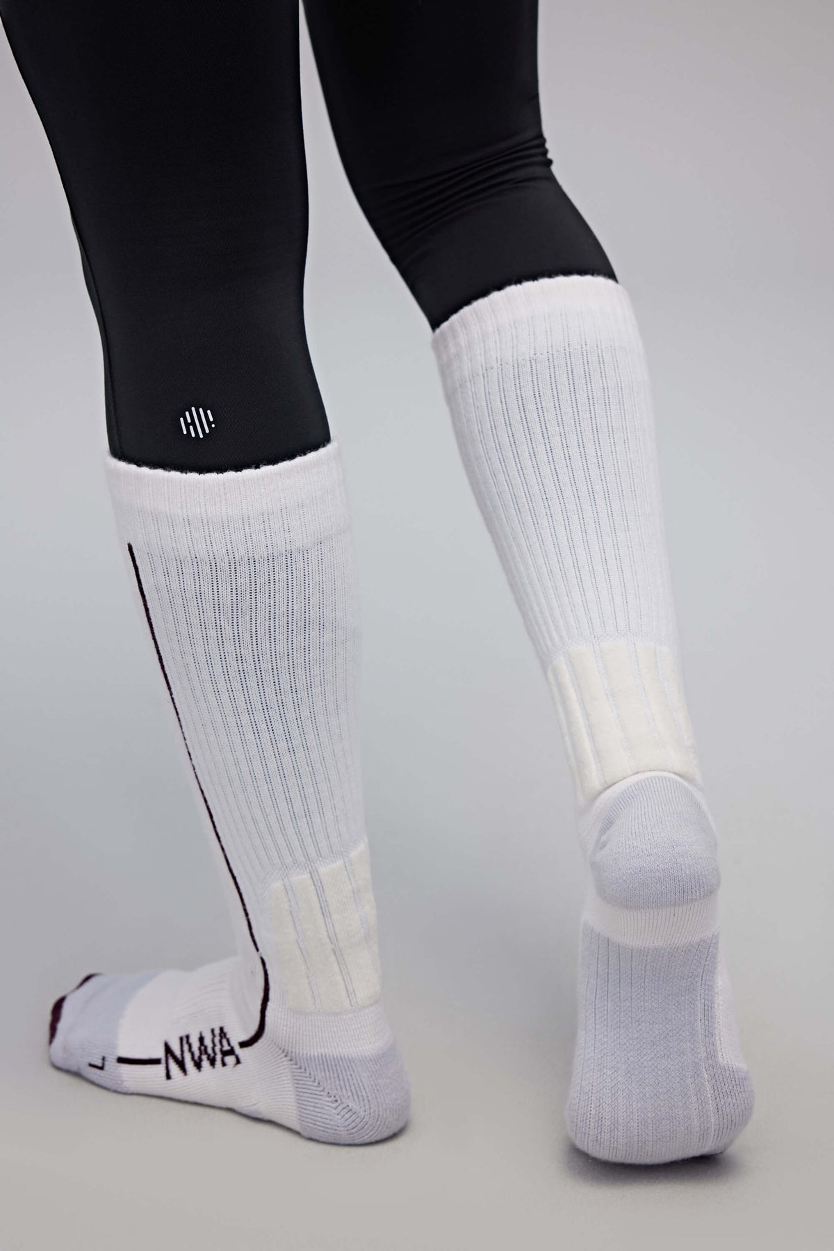 back of a person wearing white wool socks