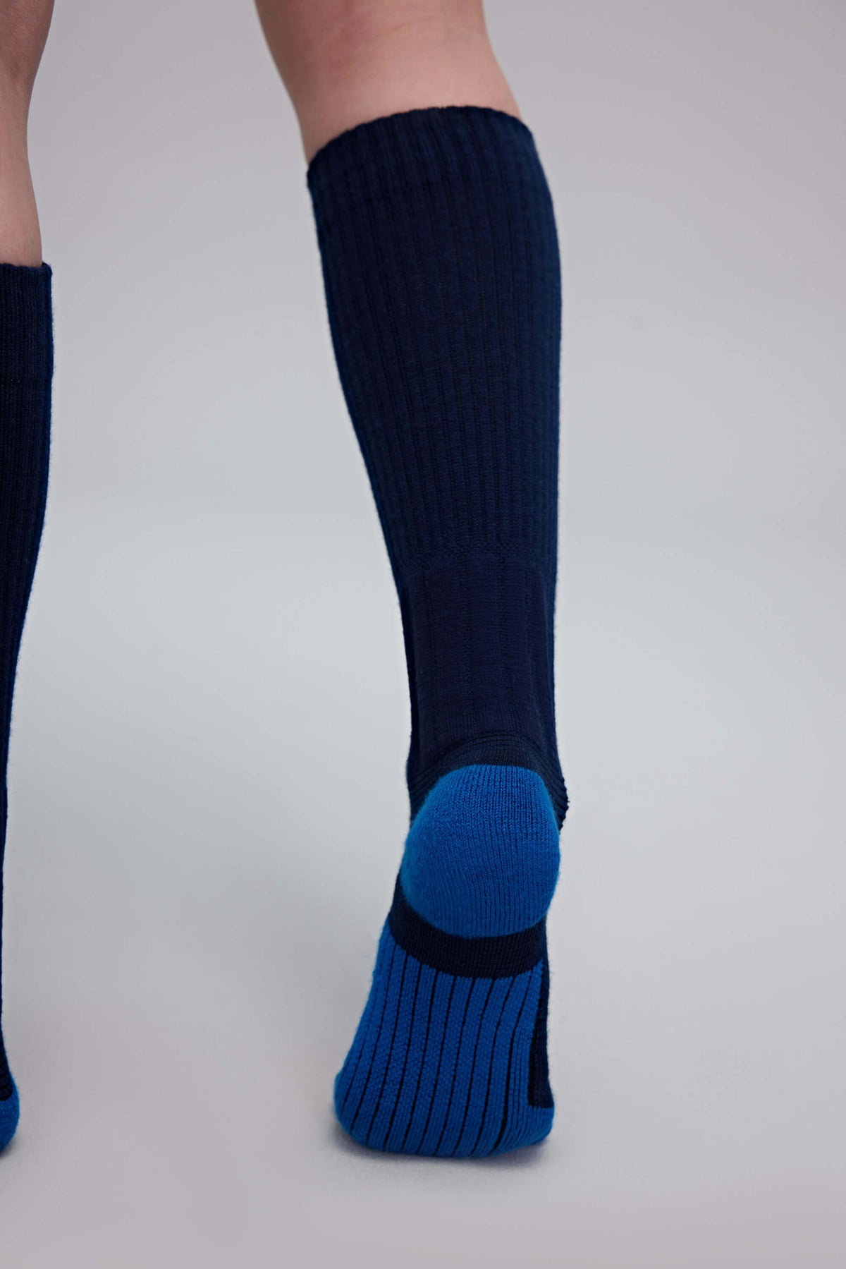 back a person wearing navy wool socks