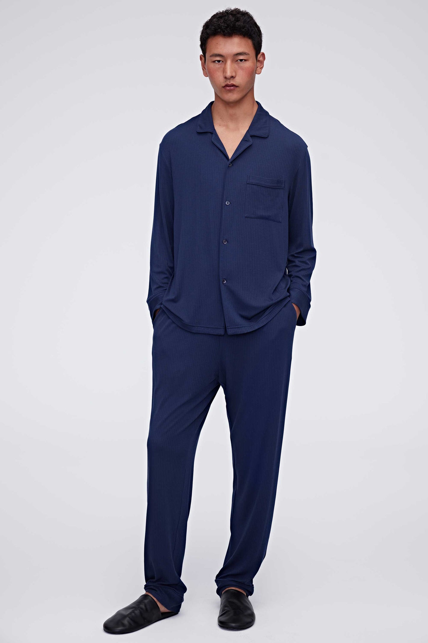 Man in navy pajama top and pants