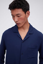 close up of man in navy pajama button up shirt