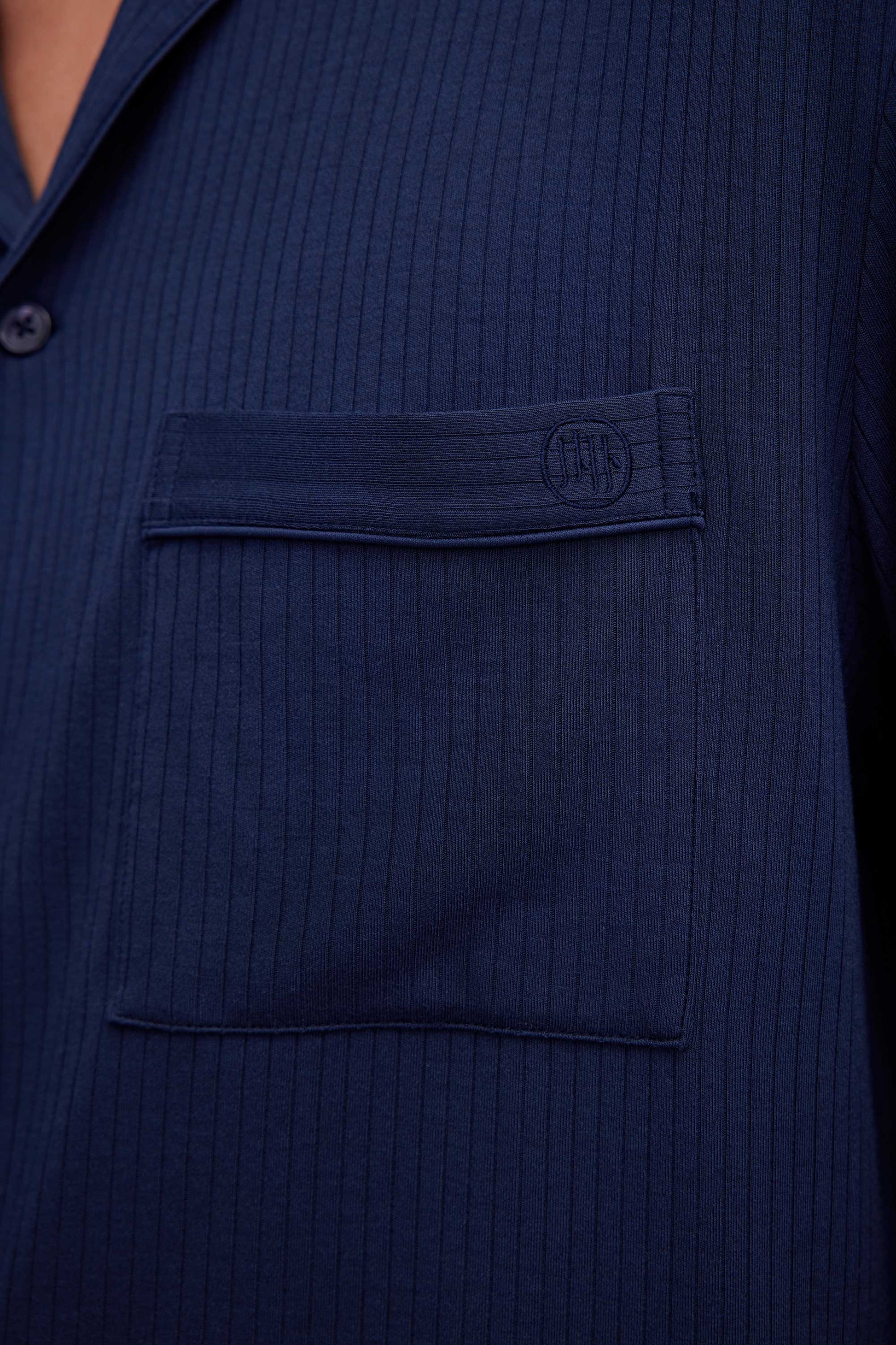 close up of man in navy pajama button up shirt