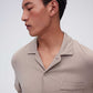 close up of man in tan pajama button up shirt