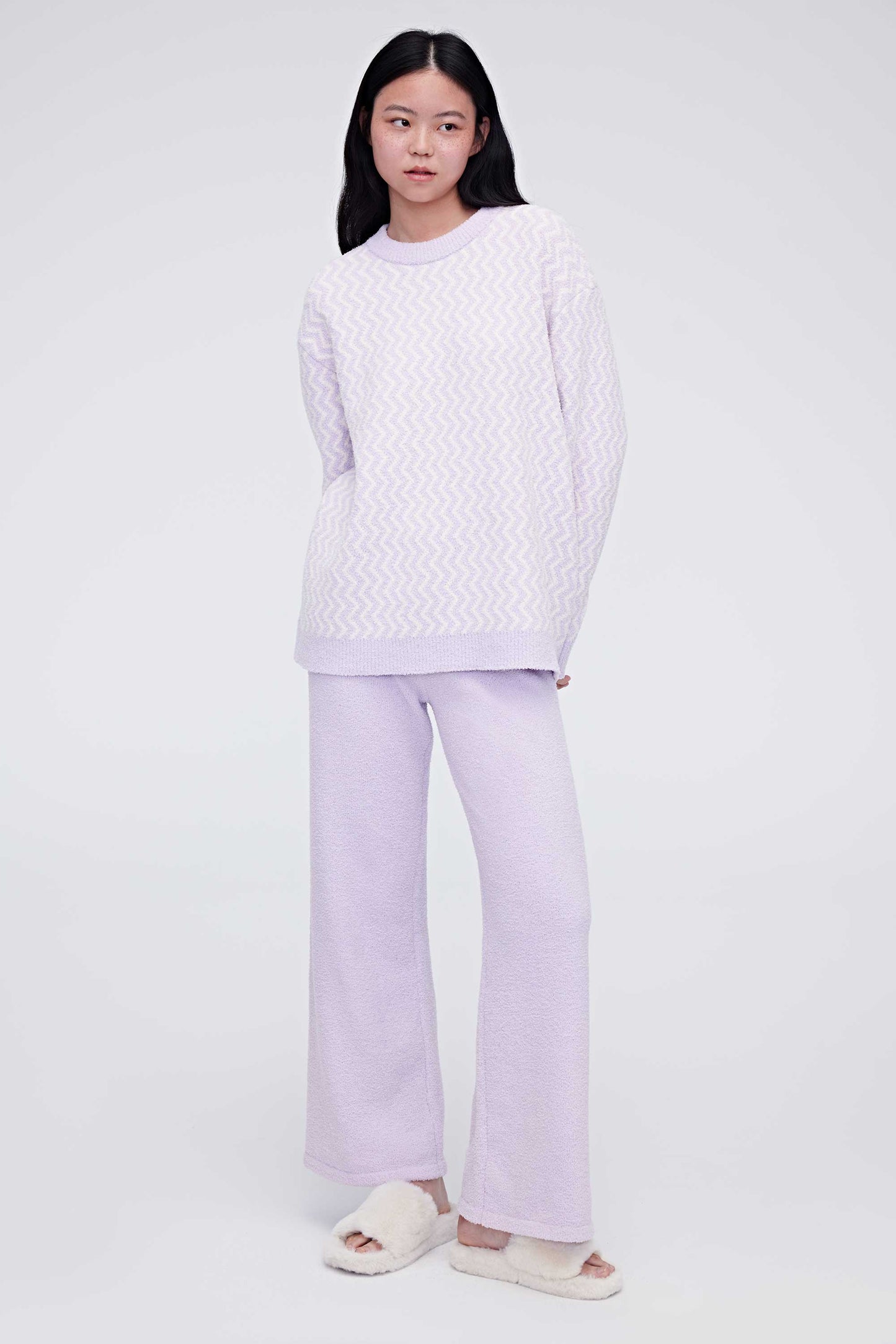 A woman wearing a purple plush fleece pajama set