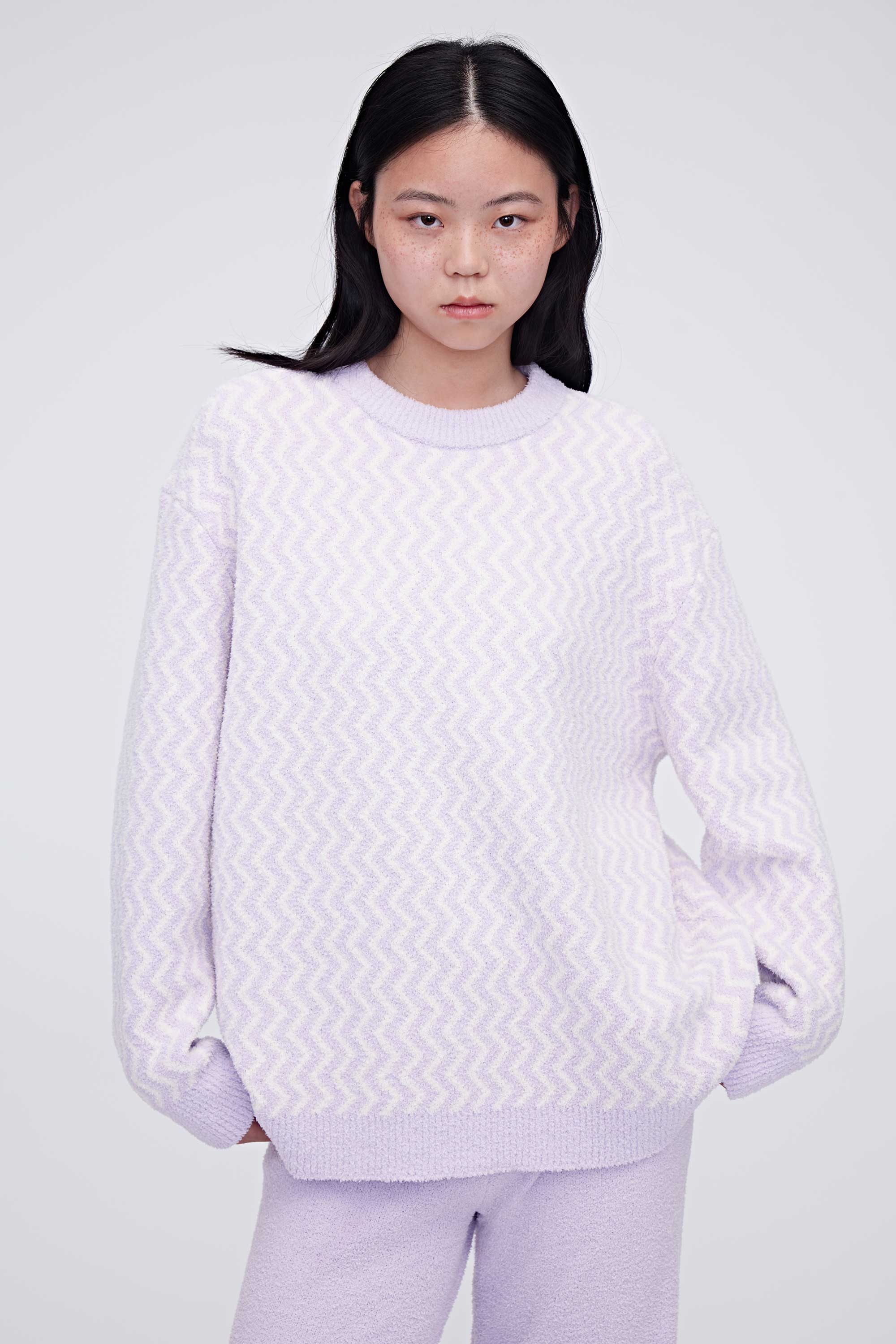 A woman wearing purple plush fleece pajama top