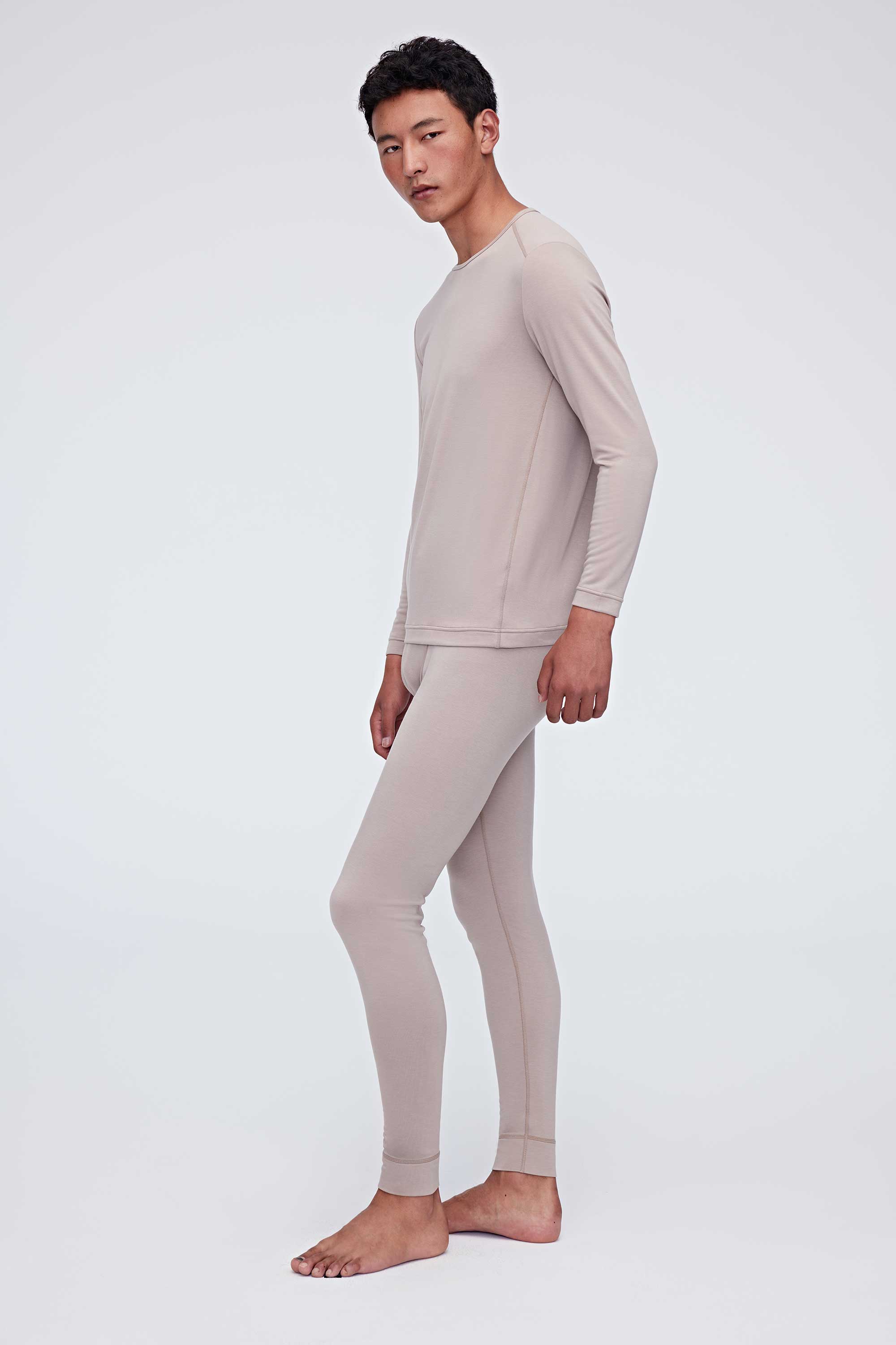 A man wears a ginger gray thermal set and faces left