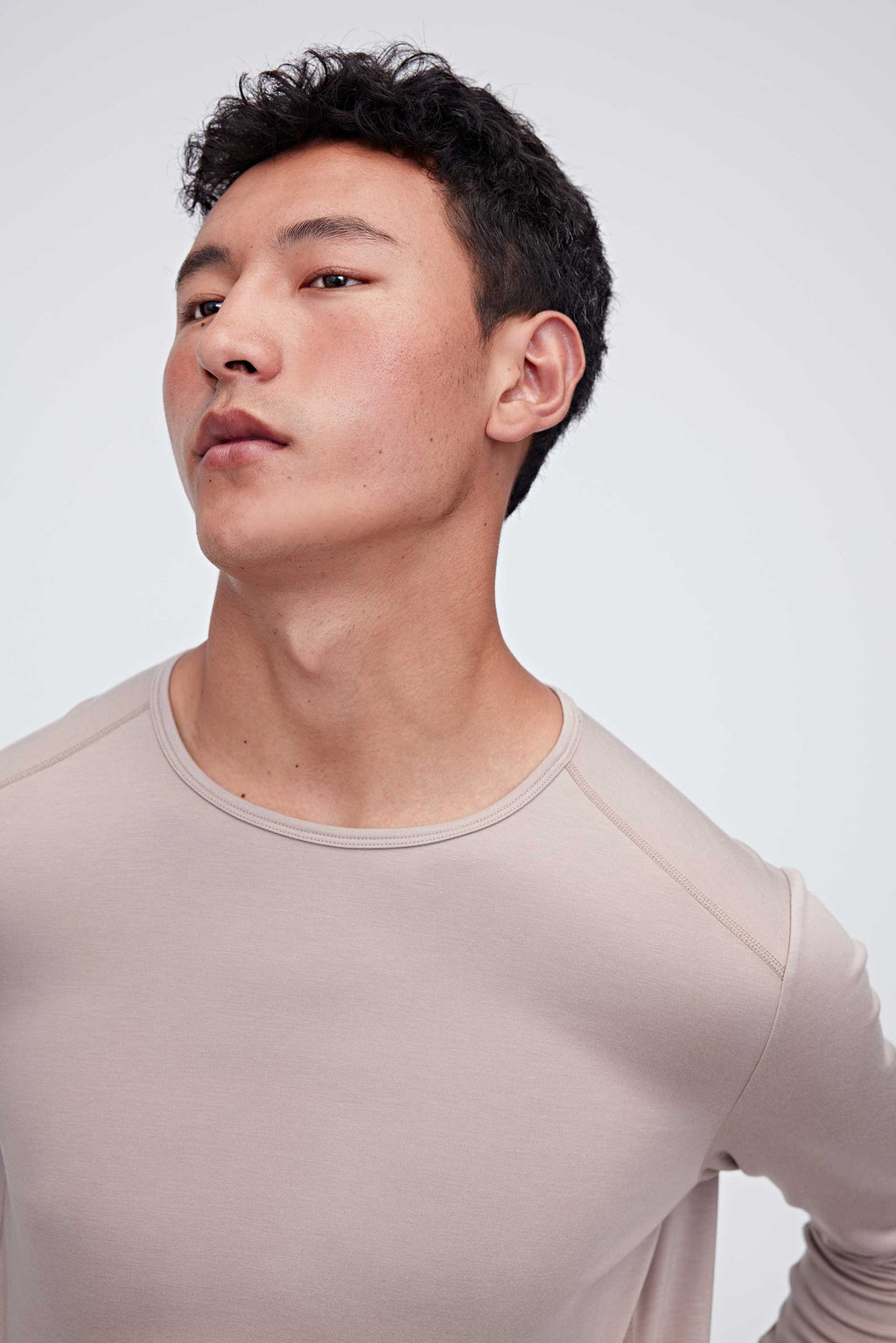 A man wearing a ginger gray thermal top