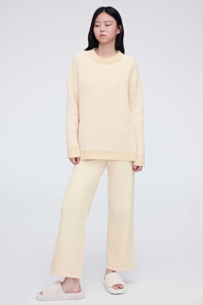 A woman wearing a yellow plush fleece pajama set