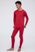 A man wears a red thermal set and faces left