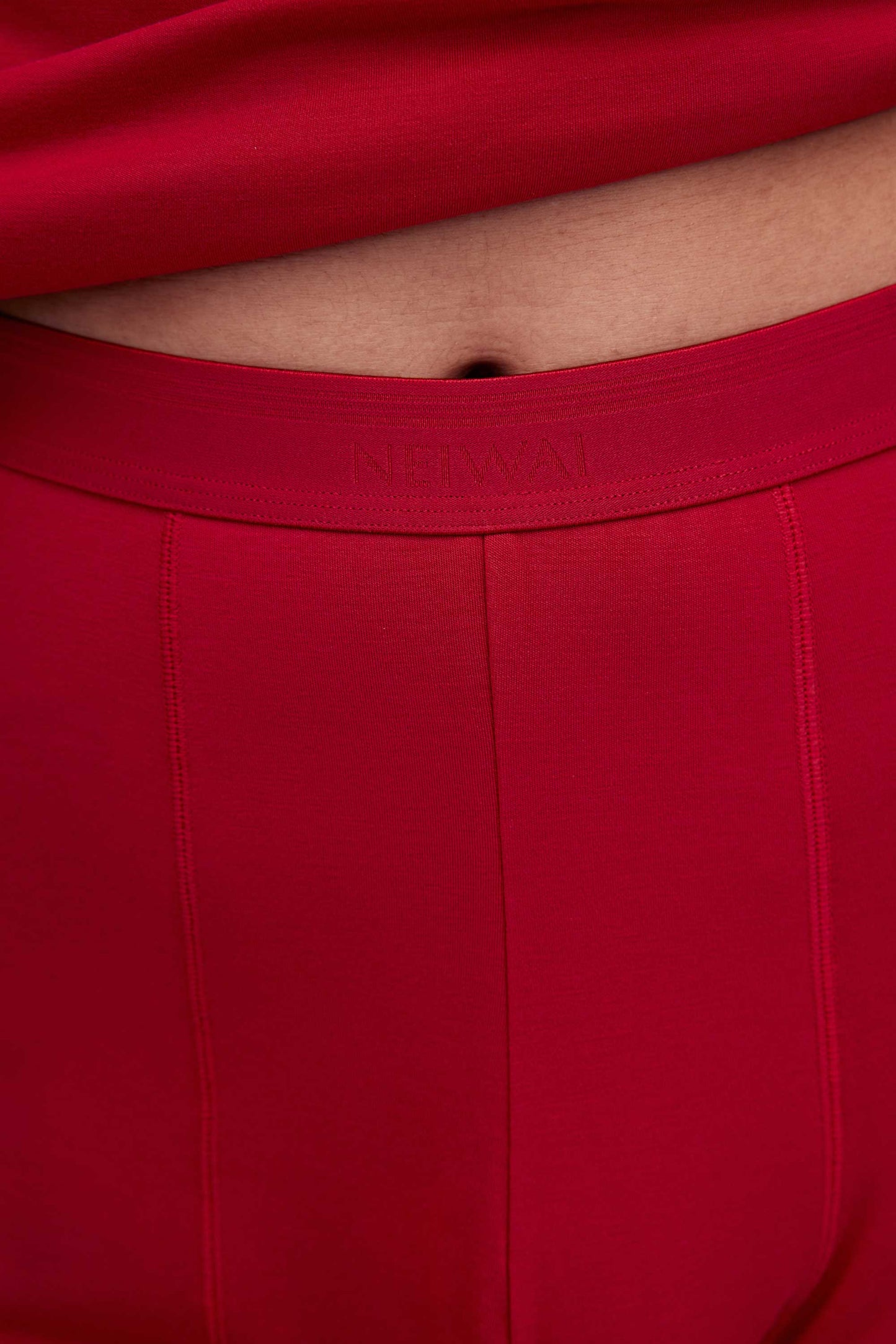 The red thermal pants have the NEIWAI logo printed on the waist band.