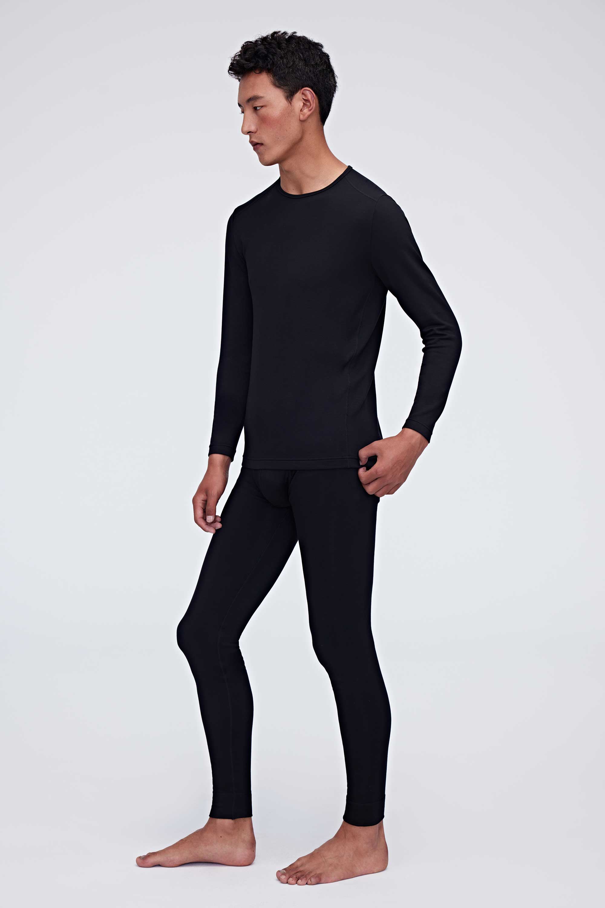 A man wearing a black thermal set and faces left