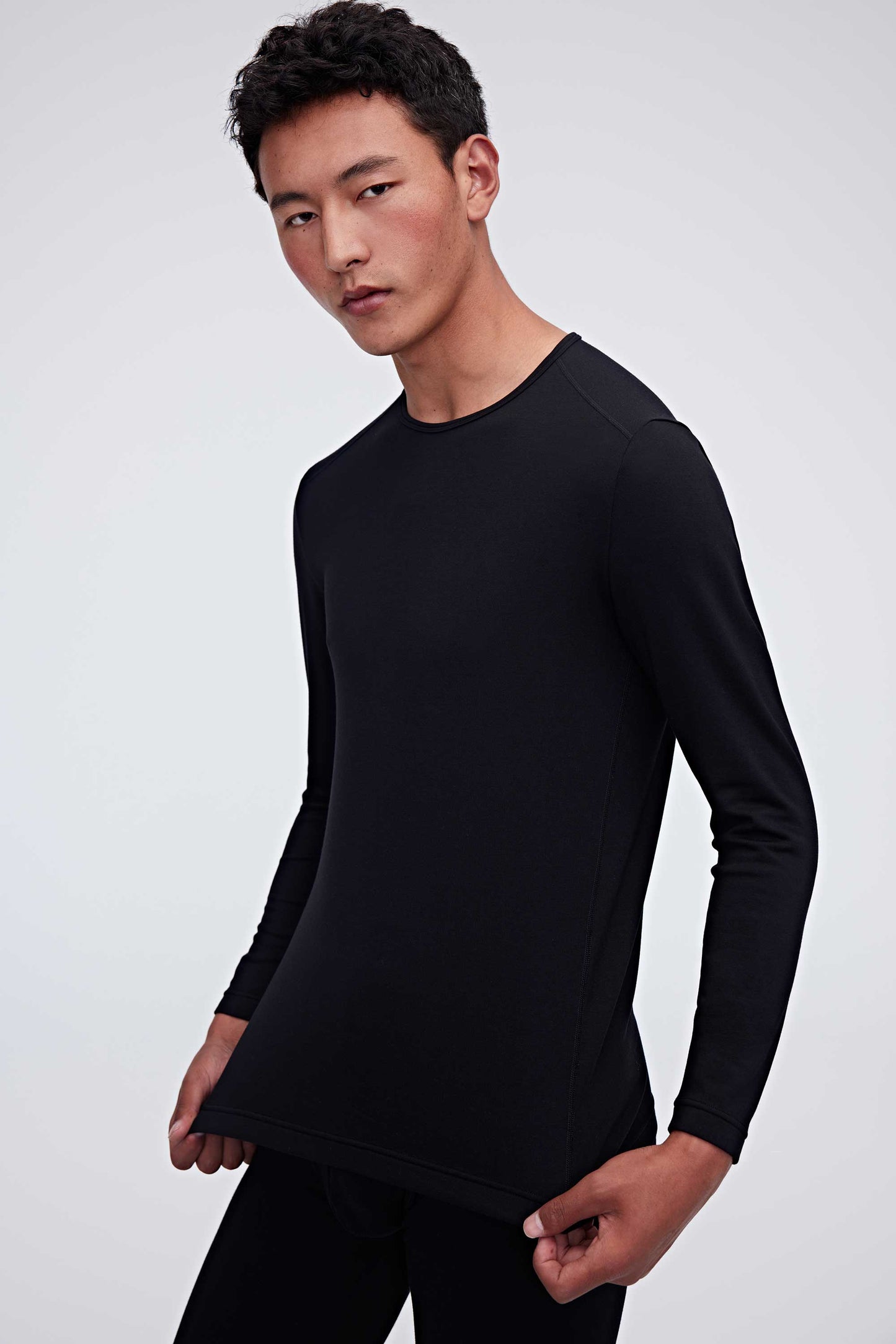 A man wearing a black thermal top
