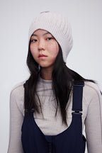 Woman wearing cream wool beanie