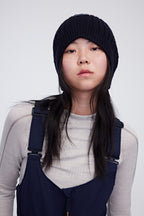 Woman wearing navy woolen beanie
