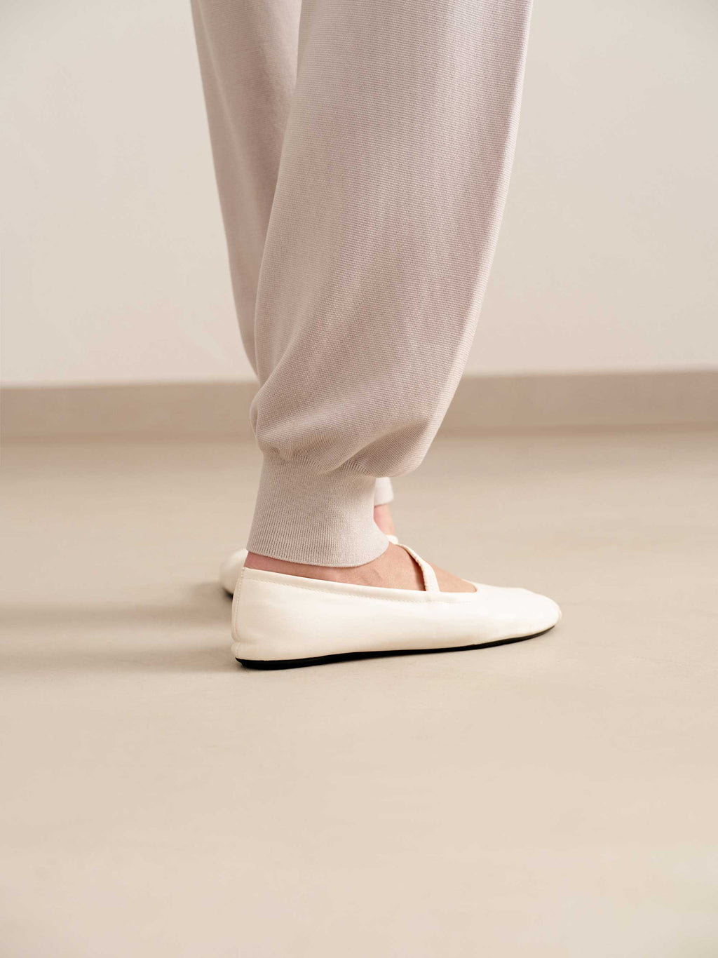 close up of woman in light pink joggers