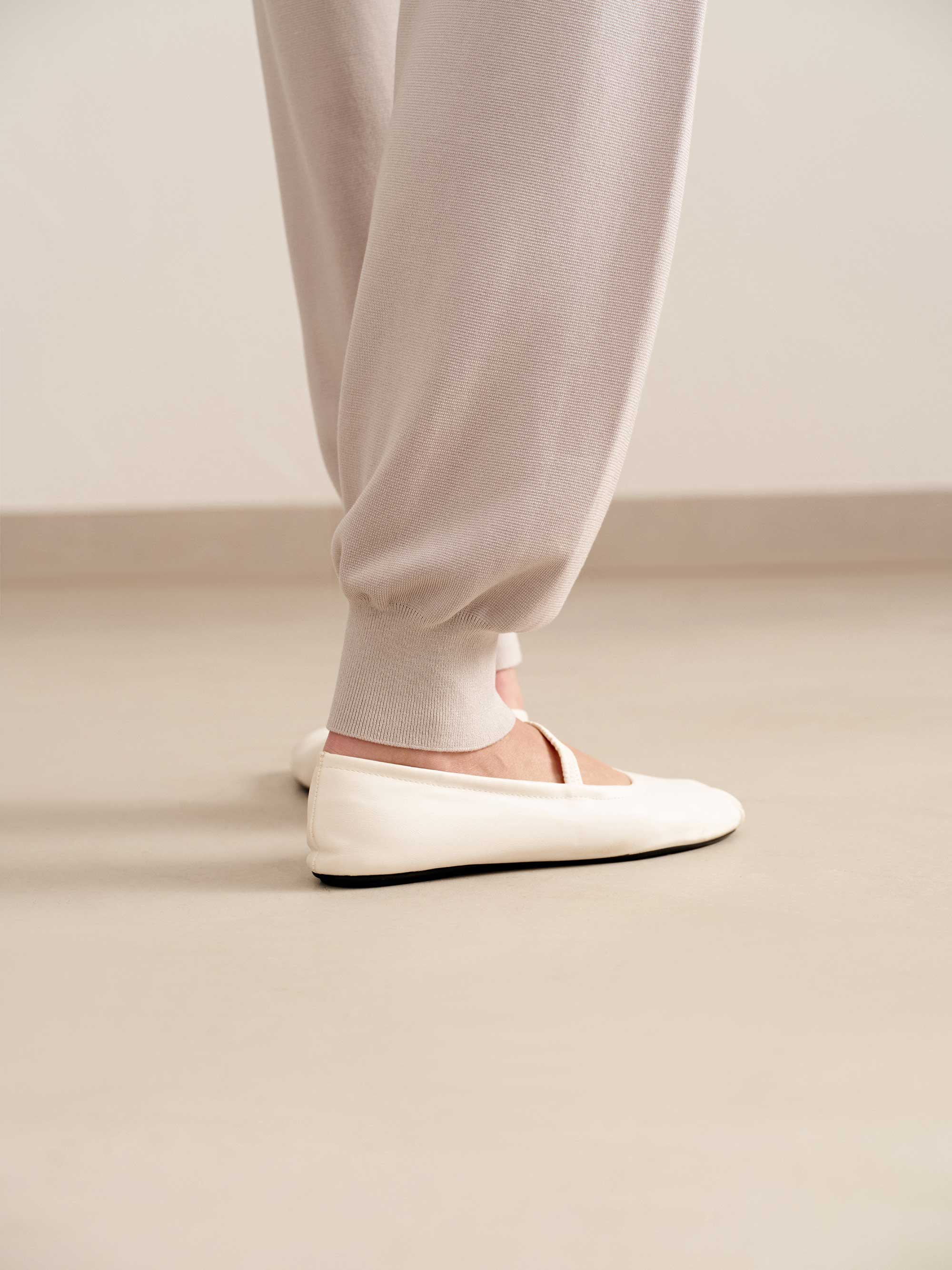 close up of woman in light pink joggers