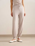 woman in light pink tank top and joggers