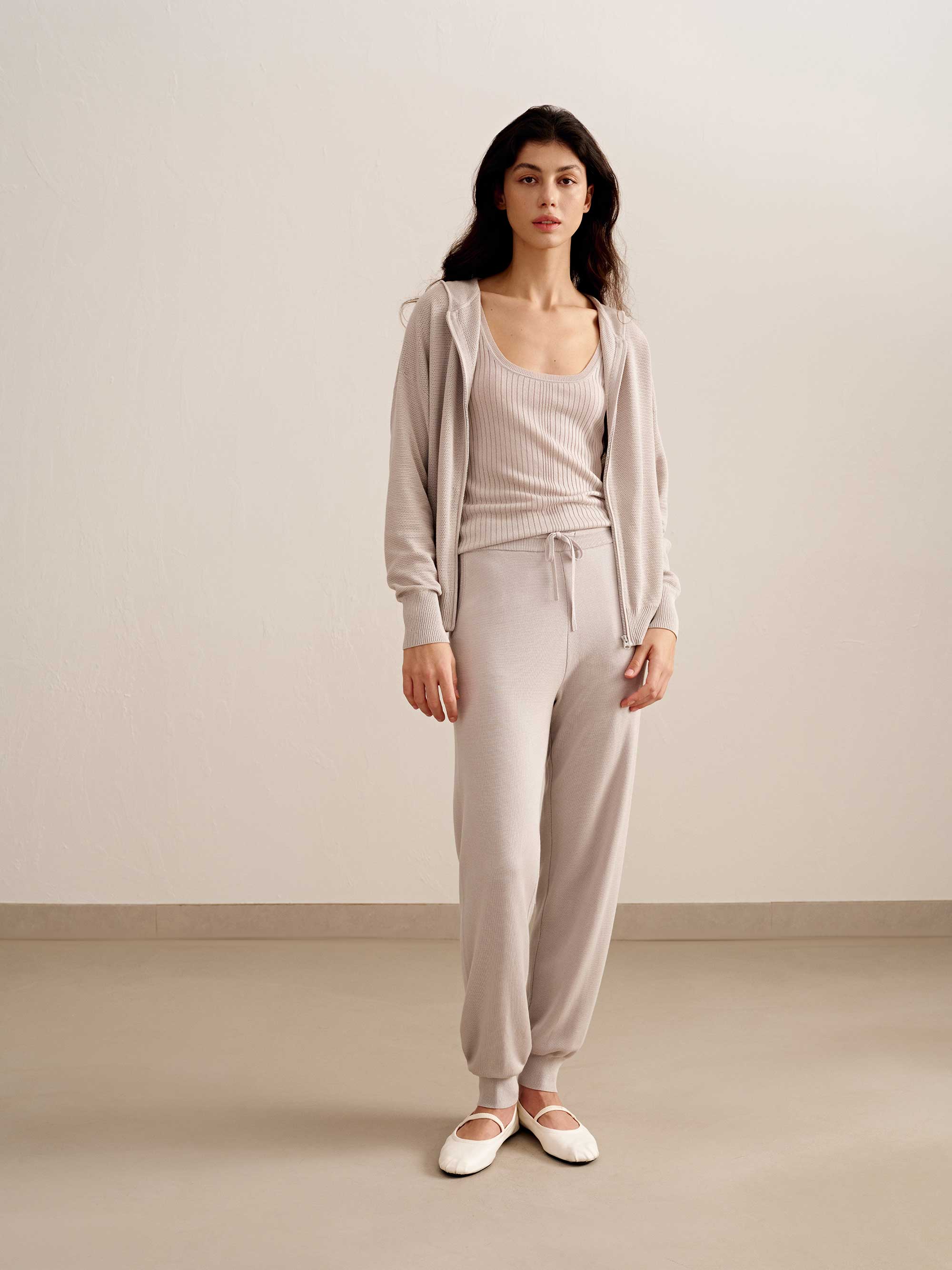 woman in light pink tank top, hoodie and joggers