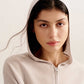 close up of woman in light pink hoodie