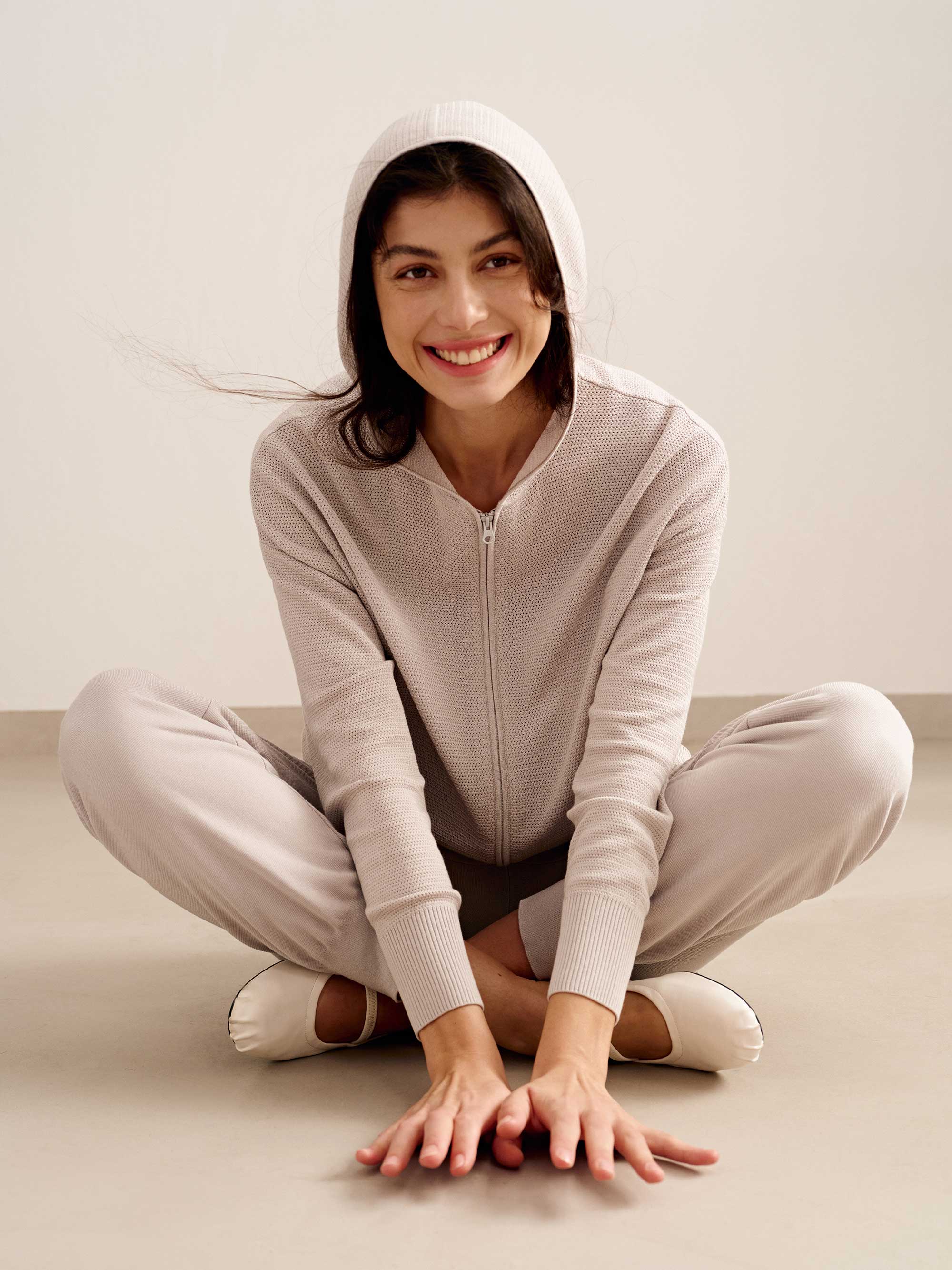 woman in light pink hoodie and joggers