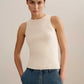 woman wearing a white tank and blue jeans